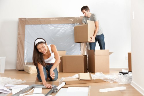 Moving boxes and furniture being unloaded at a Balham property