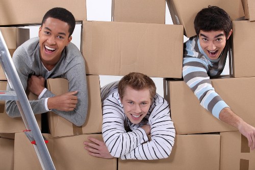 Professional office moving team handling equipment and furniture